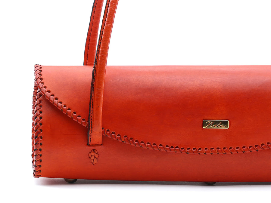 Deep Orange leather handbag with visible brand logo on a white background